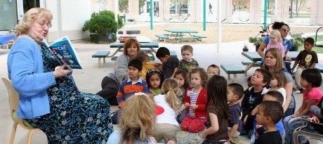 Gwen Schlange reading to children at the center
