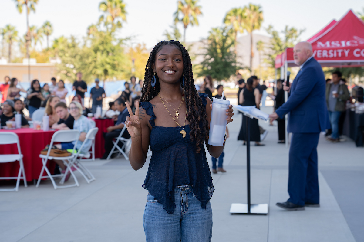 MSJC honor roll student holds up two fingers