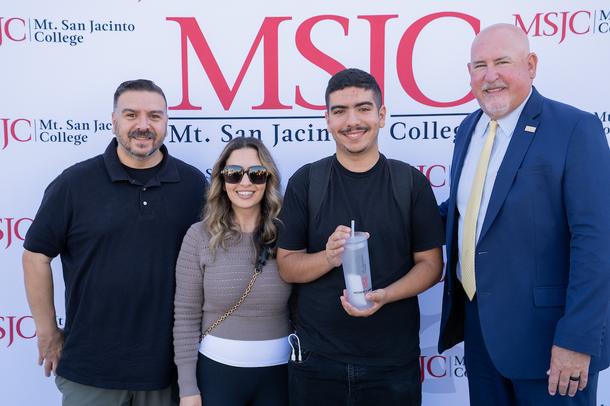 family members and student with college president Roger Schultz