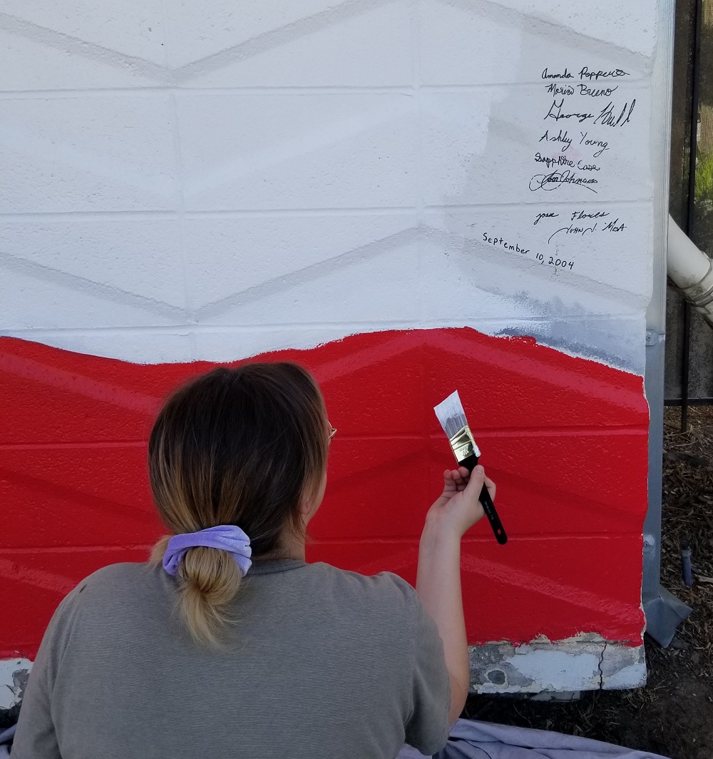 MSJC art student Vanessa Pellegrin at work refreshing the 9/11 mural