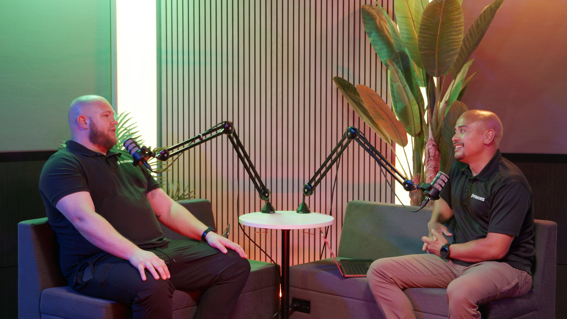 Studio 215 Two People Talking into Microphones