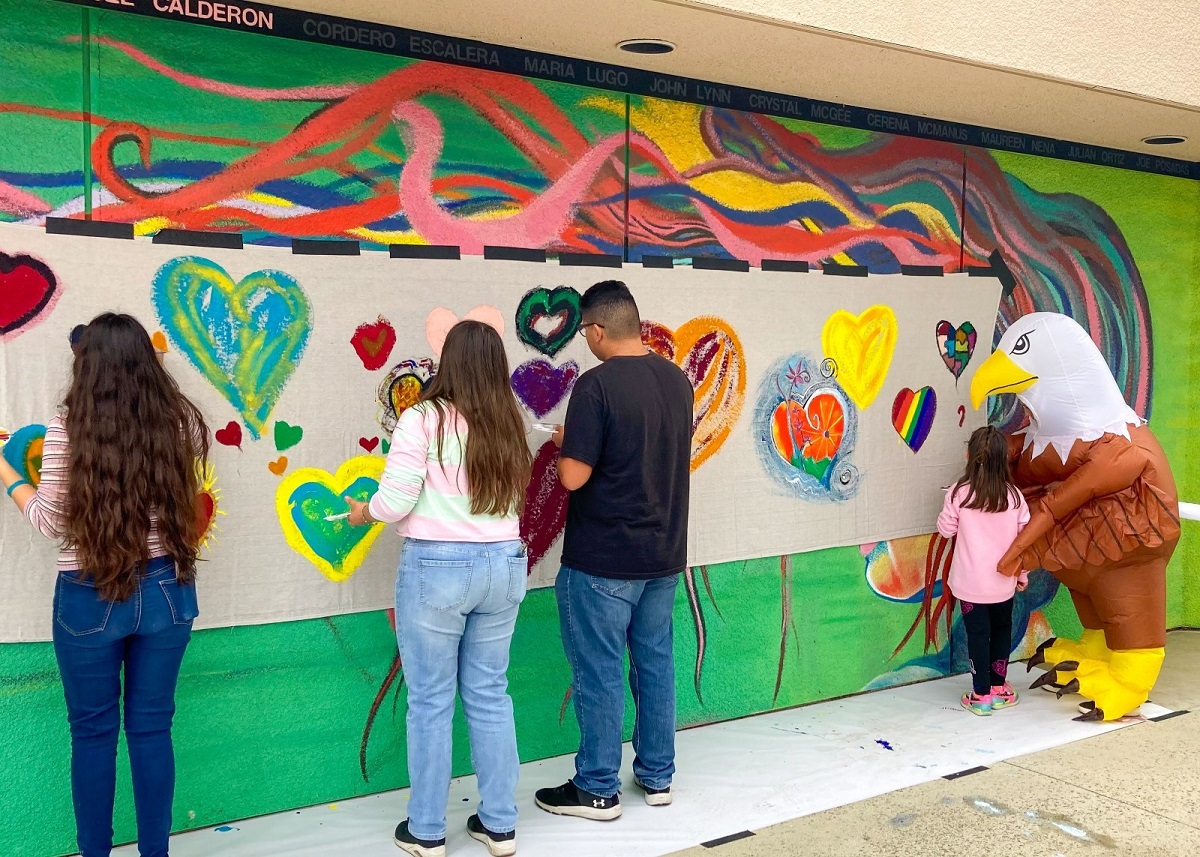 painting with Rebecca Teague in eagle costume at the MSJC Eagles Landing Community Resource Fair