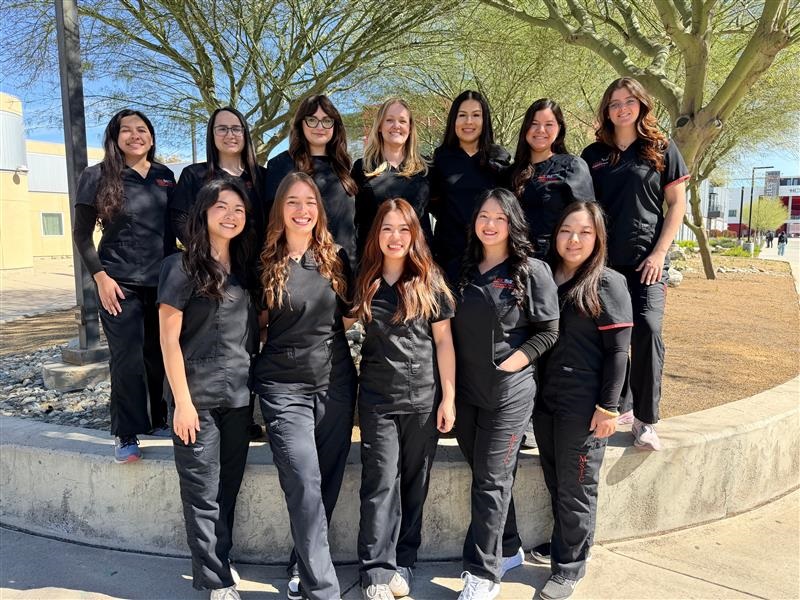 students in black medical uniforms smiling as a group. class of 2026