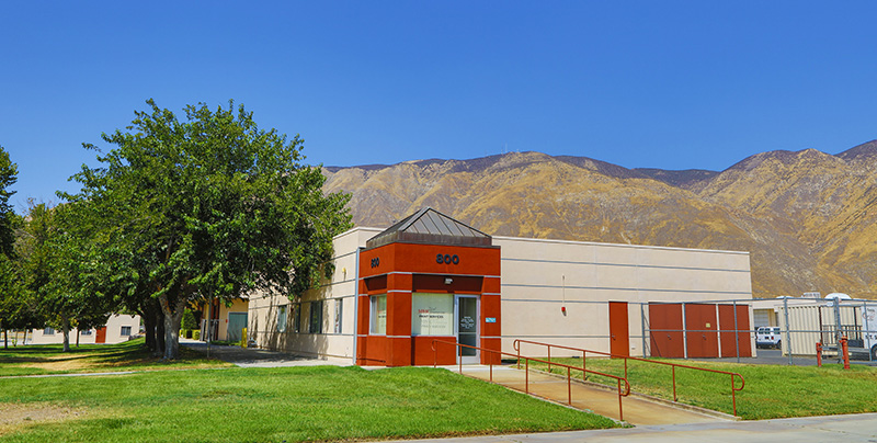print shop building exterior with mountains behind